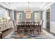 Elegant dining room with a chandelier, stylish decor, and ample seating, creating a perfect setting for formal dinners and gatherings at 7944 Park Rd, Charlotte, NC 28210