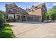 A luxurious brick home is showcased with an attached three-car garage and manicured landscaping, creating a grand and inviting entrance at 7944 Park Rd, Charlotte, NC 28210