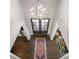 Elegant foyer featuring a chandelier, double doors, hardwood floors, and colorful rugs at 7944 Park Rd, Charlotte, NC 28210