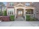 Inviting front entrance featuring stone steps, elegant columns, and a charming covered porch, exuding warmth and sophistication at 7944 Park Rd, Charlotte, NC 28210