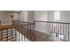 An upstairs hallway with wooden banister and staircase, showcasing architectural design at 7944 Park Rd, Charlotte, NC 28210