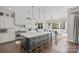 Bright open kitchen with a large island, pendant lighting, stainless steel appliances and breakfast area at 7944 Park Rd, Charlotte, NC 28210
