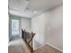 Upstairs hallway boasting neutral walls, carpet flooring, and wood railing at 8042 Downy Oak Ln, Charlotte, NC 28269