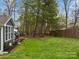 Expansive green backyard featuring lush grass, a privacy fence, and mature trees at 813 Deer Path Pl, Mooresville, NC 28115