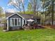 Backyard featuring a patio with outdoor furniture, a well-kept lawn, and mature trees at 813 Deer Path Pl, Mooresville, NC 28115