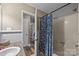 Bathroom view showing a shower with floral curtain and hallway with hardwood floors at 813 Deer Path Pl, Mooresville, NC 28115