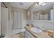 Bathroom featuring a large mirror, shower, and a vanity with a worn stone countertop at 813 Deer Path Pl, Mooresville, NC 28115