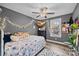 Gray bedroom featuring a ceiling fan, decorative lights, and a window view of the outdoors at 813 Deer Path Pl, Mooresville, NC 28115