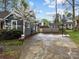 Spacious driveway with a basketball hoop, landscaping and view of side and back yard at 813 Deer Path Pl, Mooresville, NC 28115