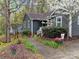 Exterior view of home showcasing charming walkway and side yard with mature trees at 813 Deer Path Pl, Mooresville, NC 28115
