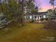 Charming front exterior with a well-manicured lawn and colorful sunset backdrop at 813 Deer Path Pl, Mooresville, NC 28115