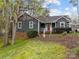 Charming home featuring a red front door and welcoming front porch and landscaped front yard at 813 Deer Path Pl, Mooresville, NC 28115