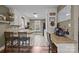 Bright kitchen with white cabinets, tile backsplash, and breakfast bar seating at 813 Deer Path Pl, Mooresville, NC 28115