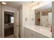 Bright bathroom featuring a white vanity with large mirror and tile shower at 9514 Wheatfield Rd, Charlotte, NC 28277