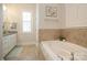 Bathroom featuring a tile shower, tub, vanity, and neutral colors at 9514 Wheatfield Rd, Charlotte, NC 28277