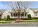 Lovely home highlighting a delightful front porch, verdant yard, and refined architectural features at 9514 Wheatfield Rd, Charlotte, NC 28277