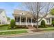 Charming home featuring a welcoming front porch, well-manicured lawn, and classic architectural details at 9514 Wheatfield Rd, Charlotte, NC 28277