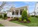 Attractive home boasting a cozy front porch, beautiful foliage, and traditional craftsmanship at 9514 Wheatfield Rd, Charlotte, NC 28277