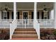 Close up of the covered porch with ceiling fans, railing and stairs to street at 9514 Wheatfield Rd, Charlotte, NC 28277