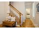 Hallway with wood stairs, lots of natural light, and access to an upstairs bathroom at 9514 Wheatfield Rd, Charlotte, NC 28277