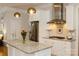 Bright kitchen with stainless steel appliances, white cabinets, and a granite island at 9514 Wheatfield Rd, Charlotte, NC 28277