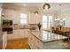 Open kitchen featuring stainless appliances, an island, and a seamless flow to the dining area at 9514 Wheatfield Rd, Charlotte, NC 28277