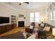 Comfortable living room with fireplace, large windows, and a cozy seating arrangement at 9514 Wheatfield Rd, Charlotte, NC 28277