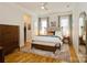 Spacious main bedroom featuring a large bed, area rug, and natural light at 9514 Wheatfield Rd, Charlotte, NC 28277