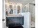 This modern bathroom features a double vanity with marble countertops and a frameless glass shower at 9710 Ainslie Downs St, Charlotte, NC 28273