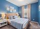 Cozy bedroom with blue walls, plush carpet, and comfortable bedding, creating a relaxing retreat at 9710 Ainslie Downs St, Charlotte, NC 28273