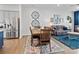 Open-concept dining area with a wooden table, colorful rug, and seamless connection to the living space at 9710 Ainslie Downs St, Charlotte, NC 28273