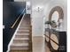 Stylish entryway features a staircase, modern decor, a round mirror, and a decorative cabinet at 9710 Ainslie Downs St, Charlotte, NC 28273