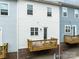 Rear exterior of the property featuring a deck and access to the living space and garage access underneath at 9710 Ainslie Downs St, Charlotte, NC 28273