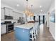 Spacious kitchen featuring an island, modern lighting, granite countertops, and stainless steel appliances at 9710 Ainslie Downs St, Charlotte, NC 28273