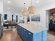 Kitchen island with granite countertops, pendant lights, seating, and stainless steel appliances at 9710 Ainslie Downs St, Charlotte, NC 28273
