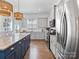 Bright kitchen features a central island, modern stainless steel appliances, and plenty of natural light at 9710 Ainslie Downs St, Charlotte, NC 28273