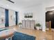 Bright living room with a media center, hardwood floors, and blue accent curtains at 9710 Ainslie Downs St, Charlotte, NC 28273