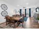 Open-concept living room and dining area with hardwood floors and lots of natural light at 9710 Ainslie Downs St, Charlotte, NC 28273