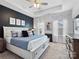 A spacious main bedroom with elegant décor, a tray ceiling, and large windows with lots of natural light at 9710 Ainslie Downs St, Charlotte, NC 28273