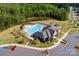 Aerial view of a community pool, clubhouse, and parking area with a red car at 9878 Verdun Ct, Fort Mill, SC 29707
