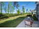 Backyard showing an outdoor dining set, expansive lawn, and black metal fence at 9878 Verdun Ct, Fort Mill, SC 29707