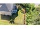 Expansive fenced backyard with a patio seating area, lush lawn, and mature trees providing ample shade at 9878 Verdun Ct, Fort Mill, SC 29707