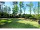 Spacious backyard featuring lush green grass and a black metal fence at 9878 Verdun Ct, Fort Mill, SC 29707