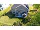 Spacious backyard with a fenced yard, featuring a patio with seating, a grilling area, and lush green grass at 9878 Verdun Ct, Fort Mill, SC 29707