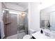 Modern bathroom featuring gray tiled shower with glass door and vanity with white countertop at 9878 Verdun Ct, Fort Mill, SC 29707