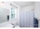 Bright bathroom features a shower with curtain, toilet, window, and modern fixtures at 9878 Verdun Ct, Fort Mill, SC 29707