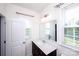 This bathroom features a dark vanity, dual windows, modern fixtures, and plenty of natural light at 9878 Verdun Ct, Fort Mill, SC 29707