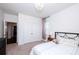 Bright bedroom featuring carpeted floors, neutral walls, closet and black metal bed frame at 9878 Verdun Ct, Fort Mill, SC 29707