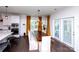 Bright dining area with a wooden table, modern lighting, and access to the outdoors at 9878 Verdun Ct, Fort Mill, SC 29707