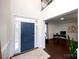 Welcoming entryway featuring a blue front door, hardwood floors, and an open view into a bright office space at 9878 Verdun Ct, Fort Mill, SC 29707